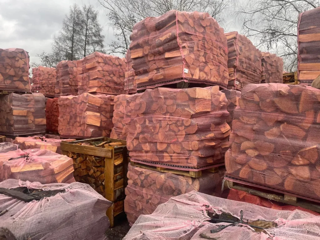 Strona główna Stos drewna opałowego ułożony na placu, gotowy do sprzedaży